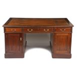 A 19th century mahogany partners desk, having a brown and gilt tooled leather top above three