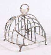 A George III silver toast rack, London 1810, maker Mary Troby, the pierced crescent handle with