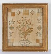 A George III needlework darning sampler by Charlotte James, worked with a central ribbon tied