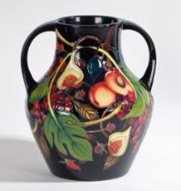 A Moorcroft twin handled pottery vase decorated in the Queens Choice pattern, circa 2000,  painted