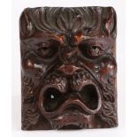 A fruitwood grotesque mask, English, circa 1600-20 With deep-set eyes, pointed ears, and open mouth,