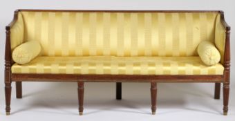 A Regency mahogany and upholstered three seater settee, having reeded cresting rail above