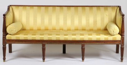 A Regency mahogany and upholstered three seater settee, having reeded cresting rail above