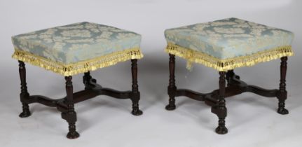 A pair of early 18th century walnut stools, circa 1700-20 Each rectangular stuff-over seat