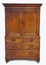 A Mid 19th century oak linen press, having a out swept cornice above a pair of cupboard doors