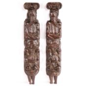 An unusual pair of late 16th century oak terms, circa 1580 Each male, wearing a round-brimmed cap,