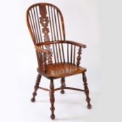 An early 19th century yew and elm Windsor armchair The hooped back with spindles either side of a