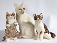 A group of three 'Winstanley' pottery seated Cats, stamped to underside, begging cat 25cm high,