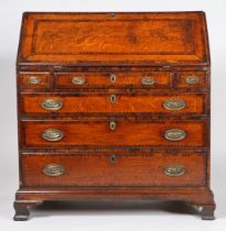 A George III oak and inlaid bureau, having a inlaid and cross banded sloping fall opening fall