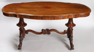 A Victorian Rosewood centre table, having a serpentine front above reeded baluster legs joined by