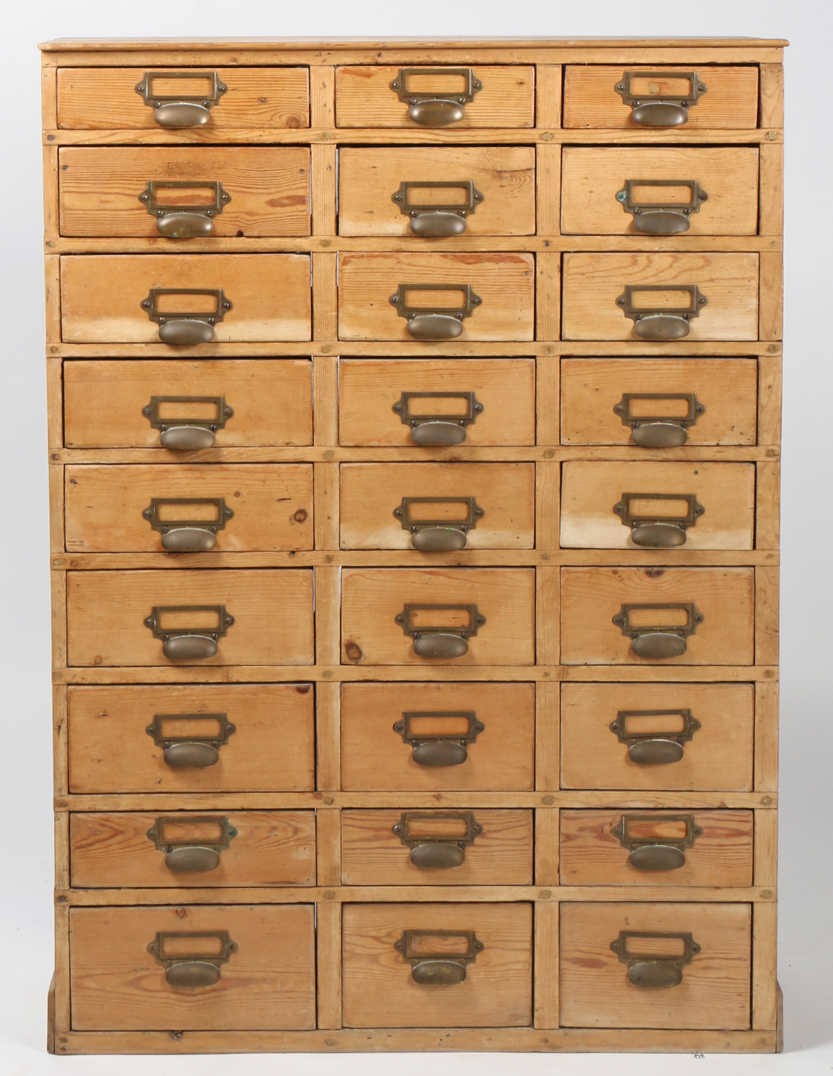 20th century industrial pine storage unit of 27 drawers, brass handles with name slots, 106cm high