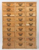 20th century industrial pine storage unit of 27 drawers, brass handles with name slots, 106cm high