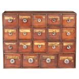 A boarded and joined pine bank of nineteen small apothecary drawers, English, circa 1830-50 The