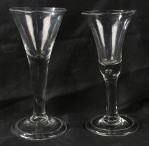 An English plain stem trumpet wine goblet, c.1750 18.5cm high, together with a further example (2)