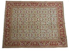 An Oriental Carpet, Probably Turkish the ivory oval lattice field with an all over design of flowing