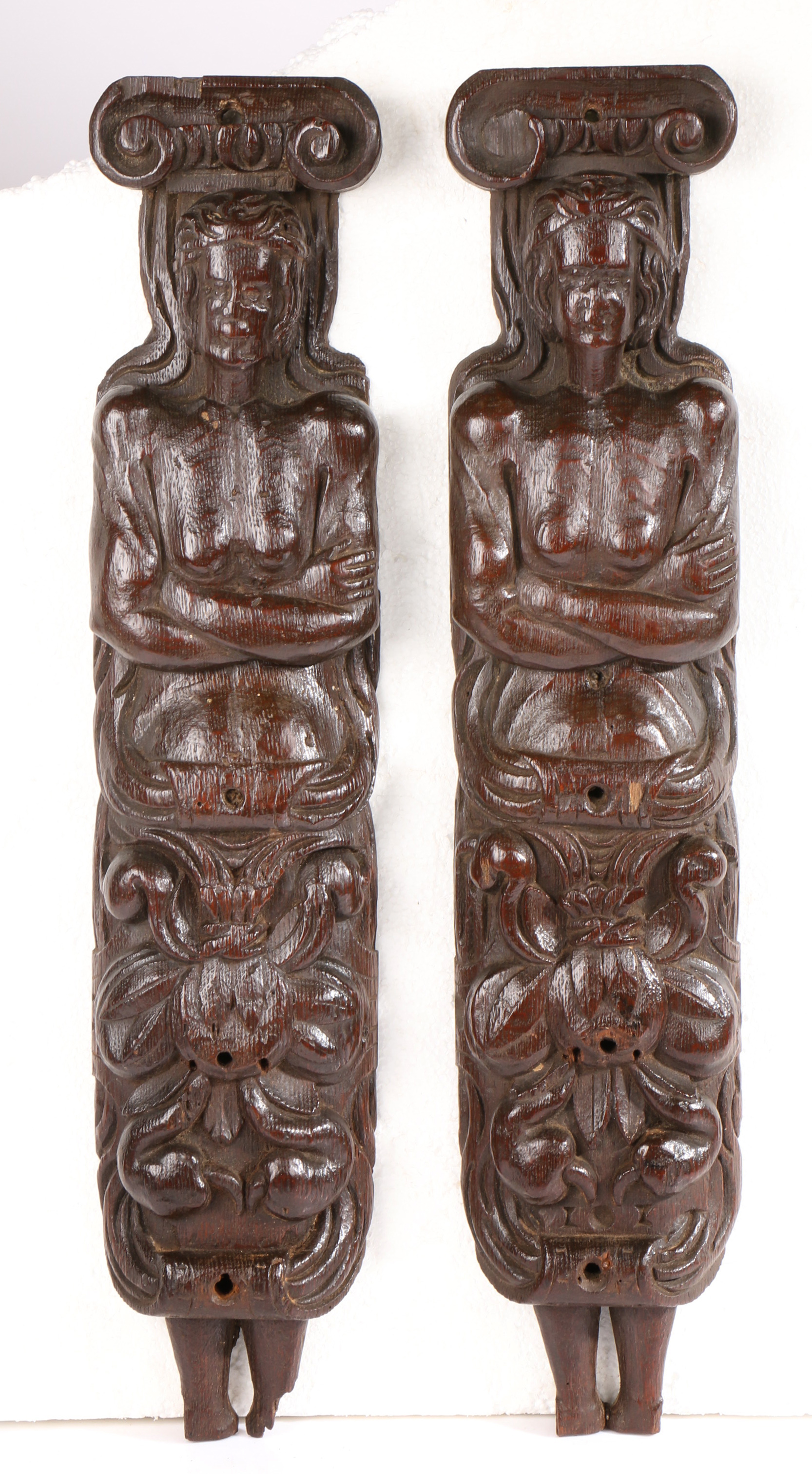 An unusual pair of late 16th century oak figural terms, circa 1580 One male, the other female,