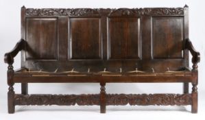 A Charles II oak settle, Cheshire/Lancashire, circa 1670 The rectangular back of four fielded