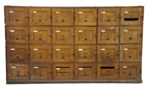 An large Early 20th century pine lockers, having twenty-four cupboards numbered 32-55 having brass