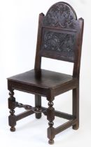 A Charles II oak backstool, Cheshire/Lancashire, circa 1670 The tall, arched, cresting carved with