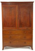 A George III flame mahogany linen press, having a pair of cupboard doors opening to reveal five