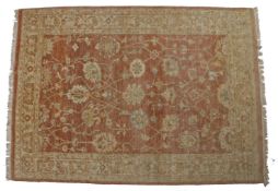 An Oriental Carpet, probably Turkish. The pale pink oval lattice field with an all over design of