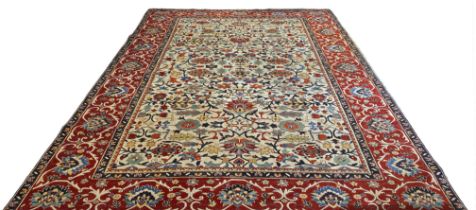 A Large Caucasian Anadol wool carpet, having a cream ground set floral motifs together with multiple