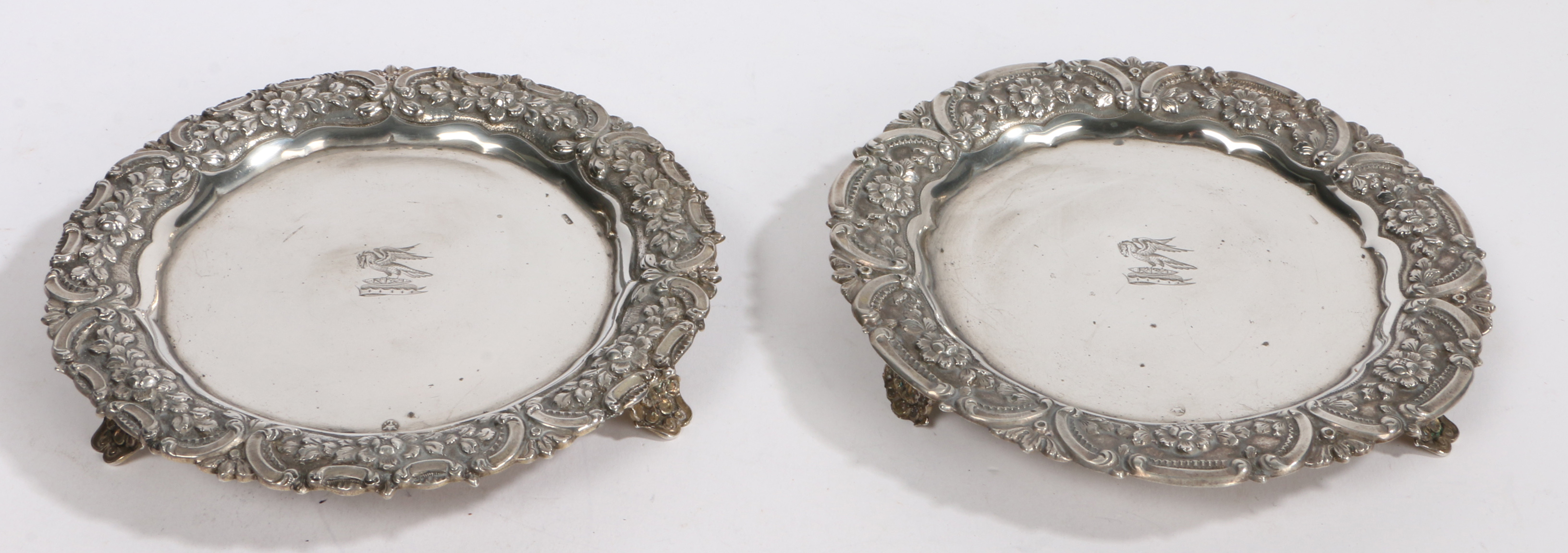 A pair of Portuguese silver dishes, Lisbon, maker S&V, with central crest depicting a bird of