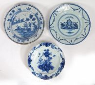 A collection of three 18th century Delft chargers The first designed with a central flower sprig and