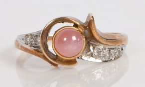 A 10 carat gold, star sapphire and diamond ring, the central pink sapphire cabochon flanked by