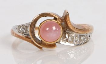 A 10 carat gold, star sapphire and diamond ring, the central pink sapphire cabochon flanked by