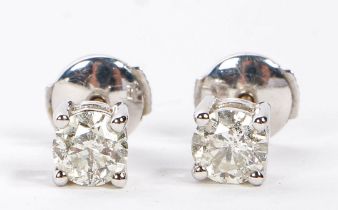 A pair of 18 carat white gold and diamond ear studs, the stones measuring 5.6 and 5.5mm diameter,