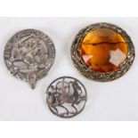 A yellow metal and cairngorm set plaid brooch, the central prismatic cut stone surrounded by a