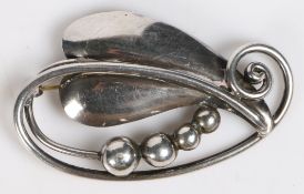 A Georg Jensen Danish sterling silver brooch, modelled as a leaf and four graduated berries, stamped