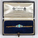 An 18 carat gold bar brooch set with a central oval opal flanked by four diamonds and a further