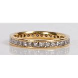 An 18 carat gold and diamond eternity ring, channel set with 32 princess cut diamonds measuring