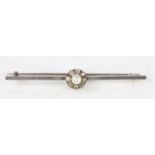 A platinum bar brooch with central pearl surrounded by a band of eight diamonds, 57.6mm wide, 4.6g