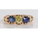 A yellow metal, diamond and sapphire ring, the head set with a central round cut diamond flanked