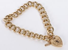 A 9 carat gold bracelet, formed from oval links with heart form padlock clasp and security chain,
