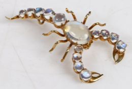 A moonstone set scorpion brooch, with cabochon cut moonstones to the body, tail and claws, 44.7mm