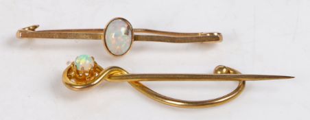 A 15 carat gold bar brooch set with a central opal, 41.5mm wide, 1.9g, a 9 carat gold stick pin