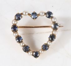 A yellow metal, sapphire and pearl heart form brooch, the pierced heart form brooch bordered with