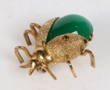 An 18 carat gold and green paste ladybird brooch, modelled with wings spread, 20.6mm wide, 20mm