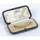 A yellow metal and pearl brooch, of crescent form set with thirteen pearls, 44mm wide