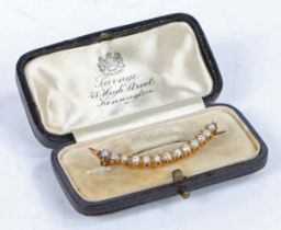 A yellow metal and pearl brooch, of crescent form set with thirteen pearls, 44mm wide
