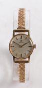 An Omega 9 carat gold ladies wristwatch, the signed silver dial with baton markers, manual wound,
