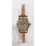 An Omega 9 carat gold ladies wristwatch, the signed silver dial with baton markers, manual wound,