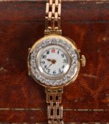 An 18 carat gold and diamond set ladies cocktail watch, the white dial with Arabic numerals, the