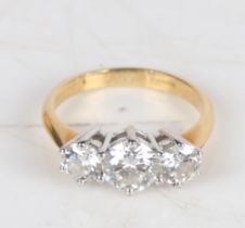 An 18 carat gold and diamond ring, the central 0.8ct diamond flanked by two 0.4ct diamonds, ring