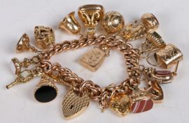 A 9 carat gold charm bracelet, with seventeen charms to include agate and bloodstone set fob