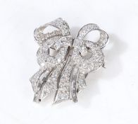 A diamond set double clip brooch, each clip set with brilliant and baguette cut diamonds, with